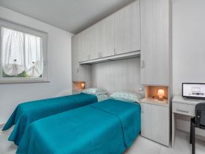 מיטה או מיטות בחדר ב-Apartments Giuliana