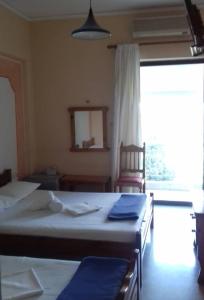 Postel nebo postele na pokoji v ubytování Hotel Ionio