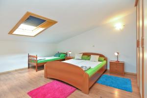 a bedroom with a bed and a couch and a window at Apartment Puzar 295 in Štinjan