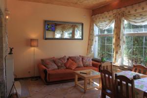 a living room with a couch and a table at Apartamenty Vesuvio in Dźwirzyno