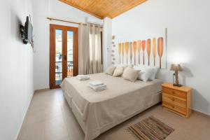 a bedroom with a large bed and a television at Elena in Symi