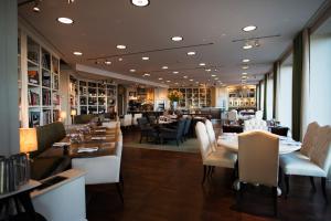 a dining room with tables and chairs and a restaurant at Lydmar Hotel in Stockholm