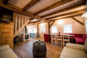 a living room with a red couch and a table at Sunny House with Sauna in Bistrica ob Sotli +42 photos