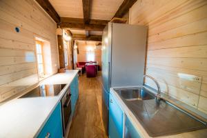 a kitchen with a sink and a refrigerator at Sunny House with Sauna in Bistrica ob Sotli