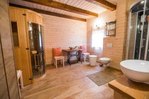 a bathroom with a sink and a table in it at Sunny House with Sauna in Bistrica ob Sotli