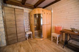 a room with a wooden cabin with a table and chairs at Sunny House with Sauna in Bistrica ob Sotli