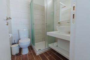 a bathroom with a toilet and a shower and a sink at River View Boutique Apts in Ayia Napa