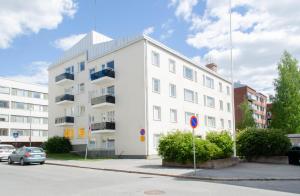 a white building on the side of a street at StarHomes Oulu, double in Oulu