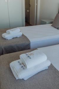 two beds with white towels on top of them at River View Boutique Apts in Ayia Napa