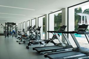 a row of cardio machines in a gym with windows at Grande Hotel De Luso in Luso