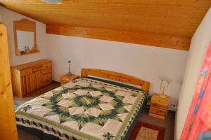 a bedroom with a bed and a wooden ceiling at Haus Alvier - CharmingStay in Flumserberg