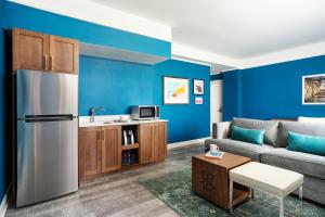 a living room with a couch and a refrigerator at The Commonwealth in Richmond