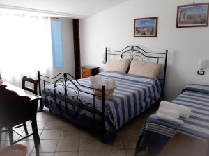 a bedroom with two beds and a table and a window at B&B La Civetta in Agropoli +58 photos