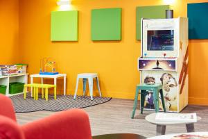 a childs room with colorful furniture and a yellow wall at ibis Styles Marseille Vieux Port in Marseille