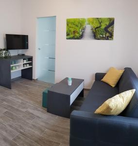 a living room with a couch and a tv at Apartment Prijeboj Plitvice Lakes in Prijeboj