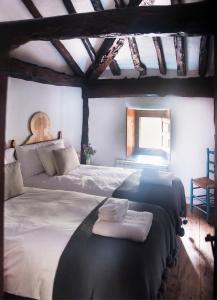a bedroom with two beds with towels on them at Molino del Feo in Las Casas Altas