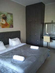 a bedroom with a large bed with two towels on it at Venus Sea View Apartment in Perivólion
