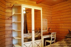 a bedroom with a desk and a bed in a cabin at Villa Iris in Yaremche