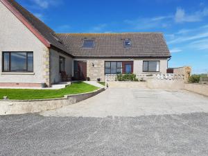 a house with a driveway in front of it at Lindisfarne Self Catering in Navershaw