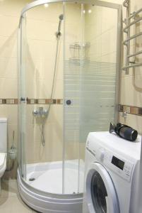 a shower in a bathroom with a washing machine at Apartments in the Center of Batumi in Batumi