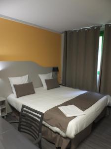 Katil atau katil-katil dalam bilik di Résidence Thermale du Parc