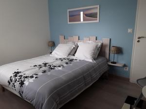 a bedroom with a large bed with white pillows at Chambre d'hôtes les Iris à Mios sur le Bassin d'Arcachon in Mios +48 photos