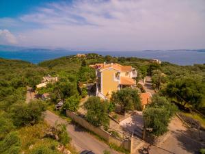 a house on a hill with the ocean in the background at Villa kortilles in Pyrgi