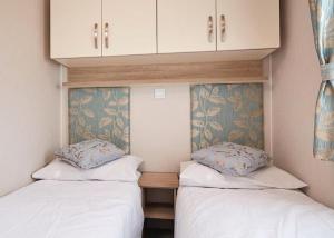 A bed or beds in a room at Chesil Vista Holiday Park