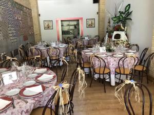 a dining room with tables and chairs with pink tablecloths at Hotel La Villoría in Medina Sidonia