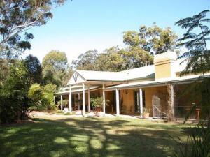 a large house with a grass yard in front of it at Smoky Cape Retreat in South West Rocks