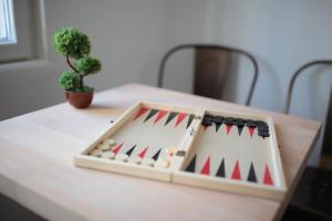 a toy chess set on a table with a plant at Hostel Musala in Varna City +107 photos