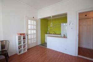a kitchen with green and white walls and a counter at Hostel Musala in Varna City