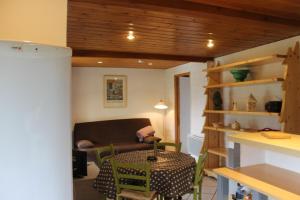 a living room with a table and a couch at soleil et vue in Barcelonnette