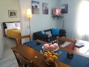 a room with a table with a bowl of fruit on it at Siviri family house Oikismos Akri - Koroni in Siviri