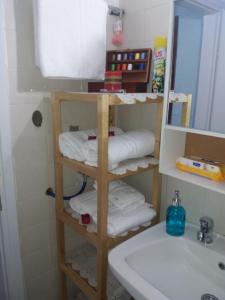 a bathroom with a shelf with towels and a sink at Siviri family house Oikismos Akri - Koroni in Siviri +28 photos