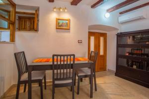 a dining room with a table and chairs at Apartment Rialto with private parking in Cres