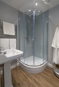 a bathroom with a shower and a sink at Willoughby Apartment in Bath