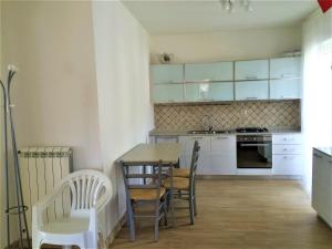 a kitchen with a table and chairs in a room at Villa sul Mare in Belvedere Marittimo