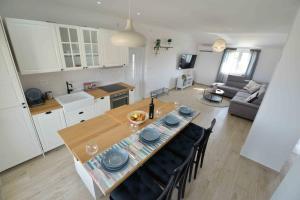 kuchnia i salon ze stołem i krzesłami w obiekcie Apartments Enida w mieście Betina