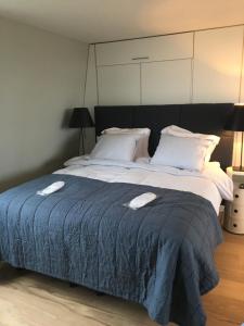 
a neatly made bed with a white comforter at BB Museumquarter in Amsterdam
