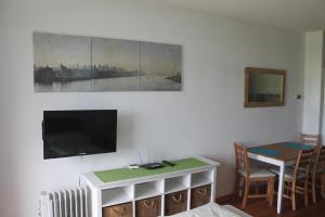 a living room with a flat screen tv on a wall at Ferienwohnung im Haus Landskron in Landskron