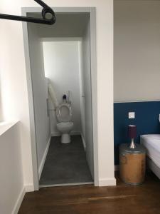a bathroom with a toilet in a hallway at O' li douillet in Les Épesses