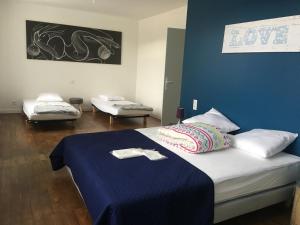 a bedroom with a bed with a blue wall at O' li douillet in Les Épesses +55 photos