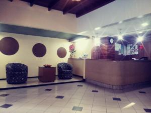 a restaurant with a waiting area with a counter and chairs at Seamar Hotel in Fortaleza