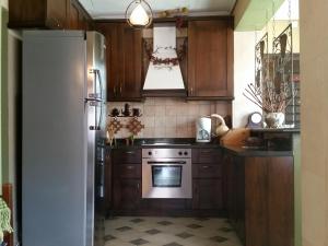 a kitchen with a white refrigerator and a stove at DOWN TOWN LUXURY Apartment in Sarandë