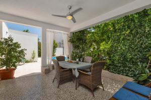 a patio with a table and chairs and plants at Apartment Mediteraneo in Makarska
