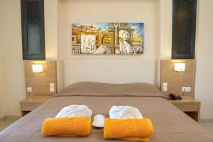 A bed or beds in a room at Aeolian Gaea Hotel