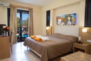 a hotel room with a bed and a balcony at Aeolian Gaea Hotel in Skala Kallonis +63 photos