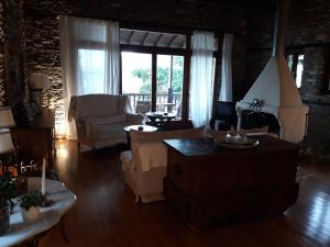 a living room with a couch and a table at House Smaragdi in Agios Ioannis Pelio