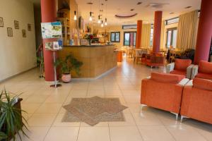 a lobby with chairs and a counter in a restaurant at Aeolian Gaea Hotel in Skala Kallonis
